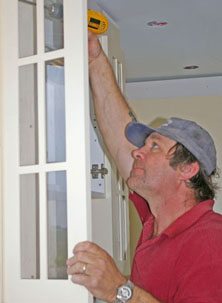 man attaches glass door